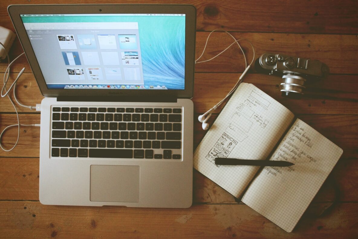 open laptop on left, open notebook on right